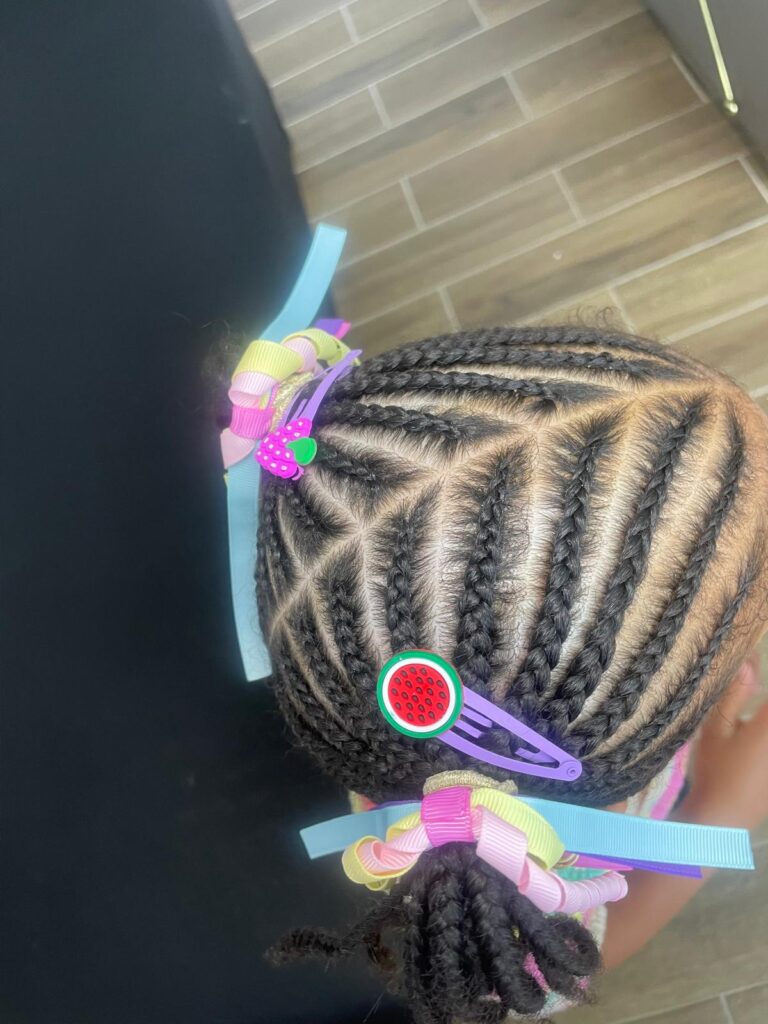 Kids cornrows with zig zag pattern and colourful clips by Lorellin Hair & Beauty in Wolverhampton