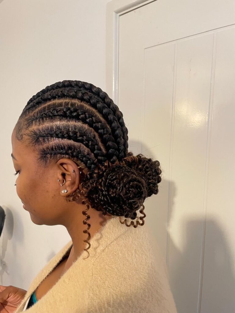 Feed in cornrows with curly low bun by Lorellin Hair & Beauty in Wolverhampton