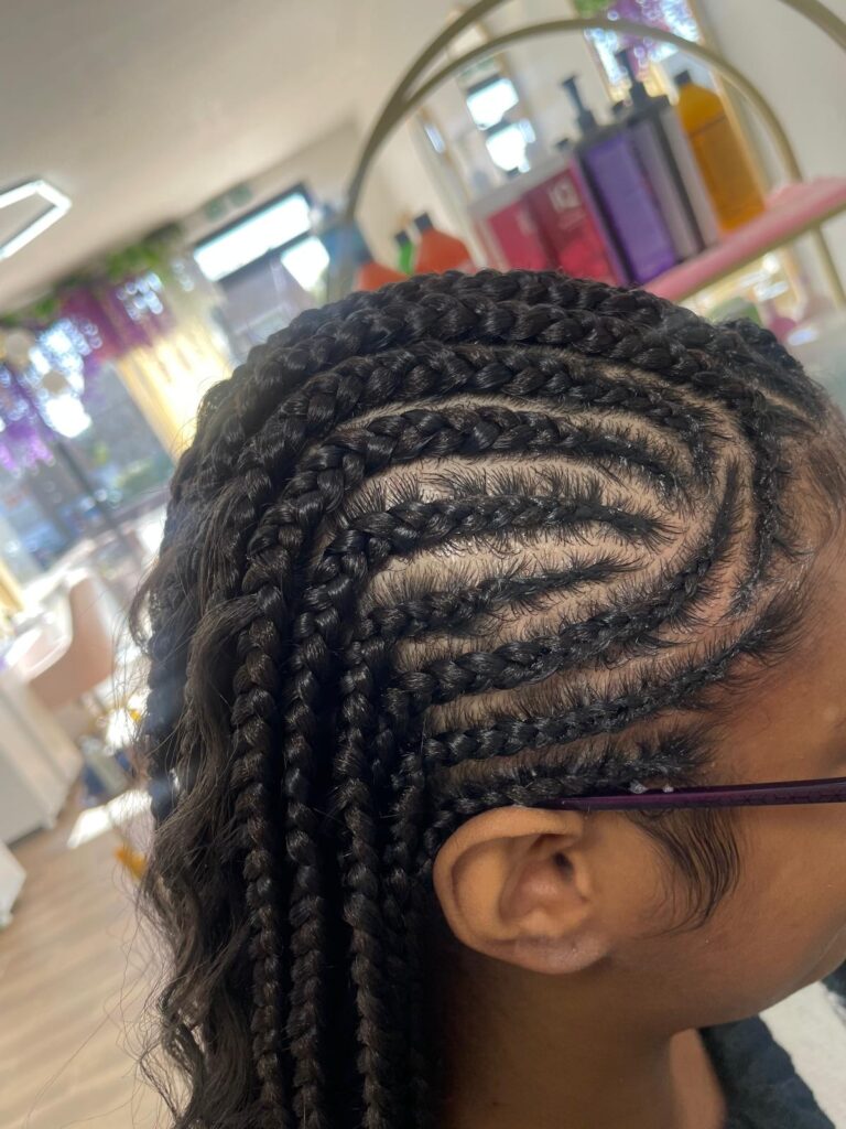 Side view cornrows with curved pattern and neat edges by Lorellin Hair & Beauty in Wolverhampton