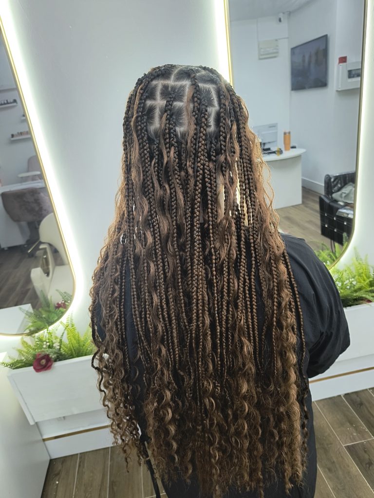 Back view of long box braids with curls, styled at Lorellin Salon in Bilston.