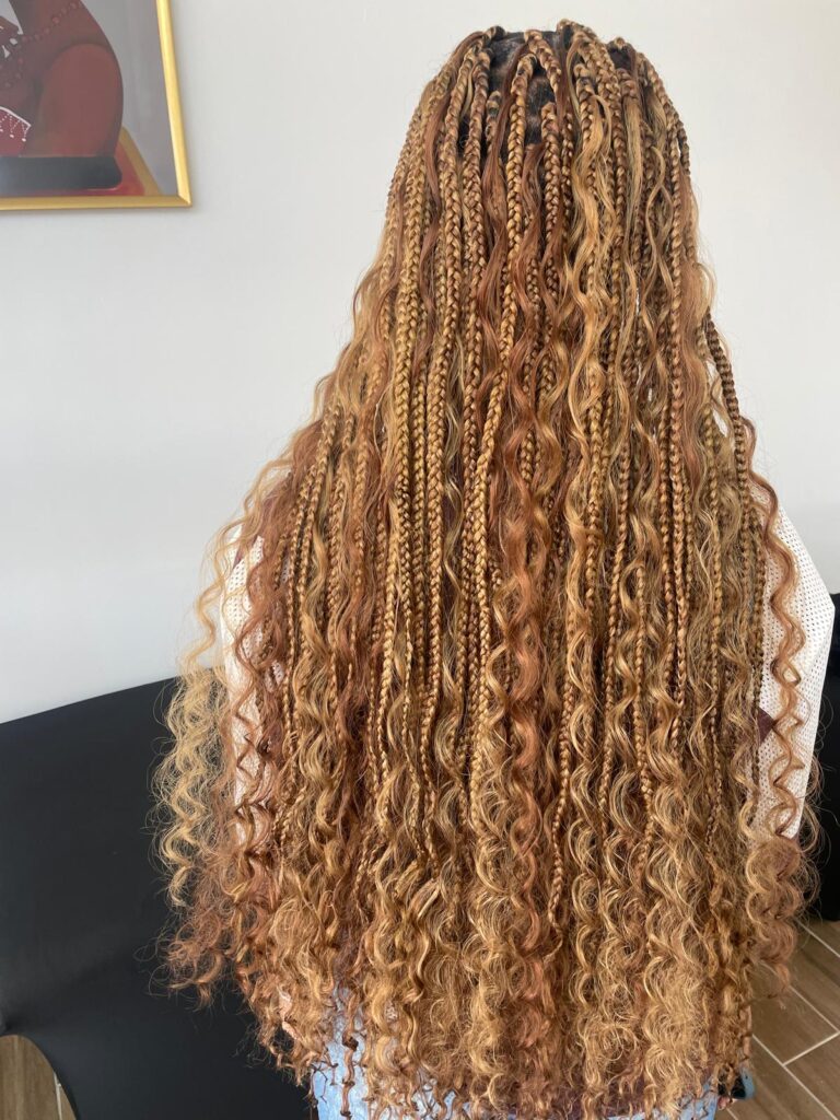 Long blonde boho knotless braids with curls by Lorellin Hair & Beauty in Wolverhampton