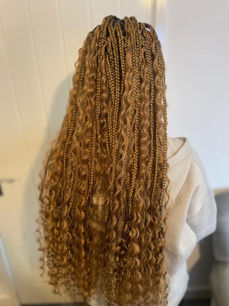Long blonde boho knotless braids with curls by Lorellin Hair & Beauty in Wolverhampton