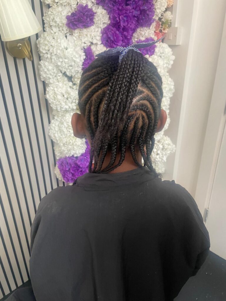 Kids cornrows with swirl pattern and ponytail by Lorellin Hair & Beauty in Wolverhampton