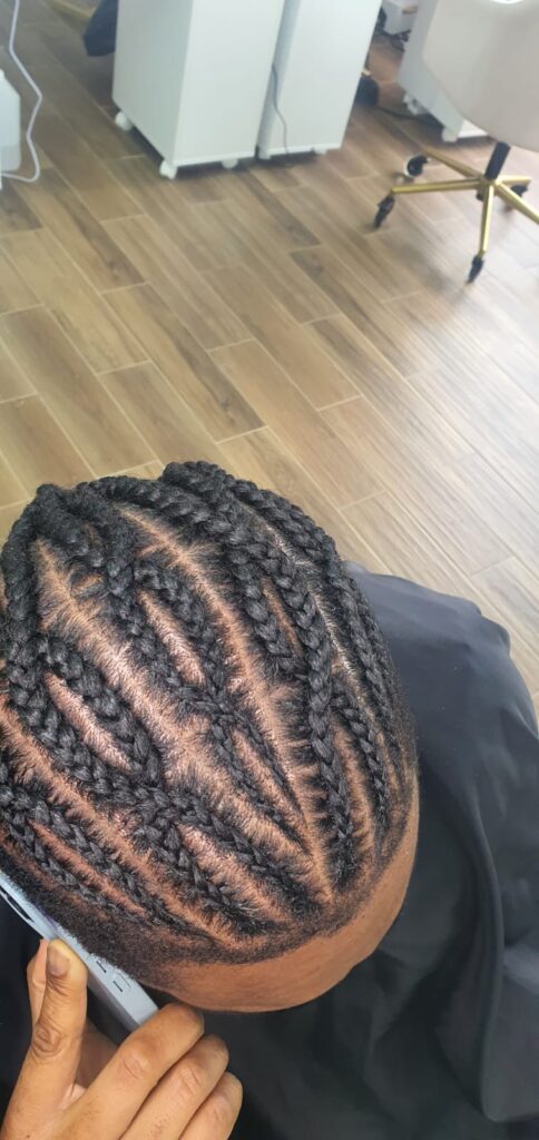 Neat feed in cornrows with detailed parting by Lorellin Hair & Beauty in Wolverhampton
