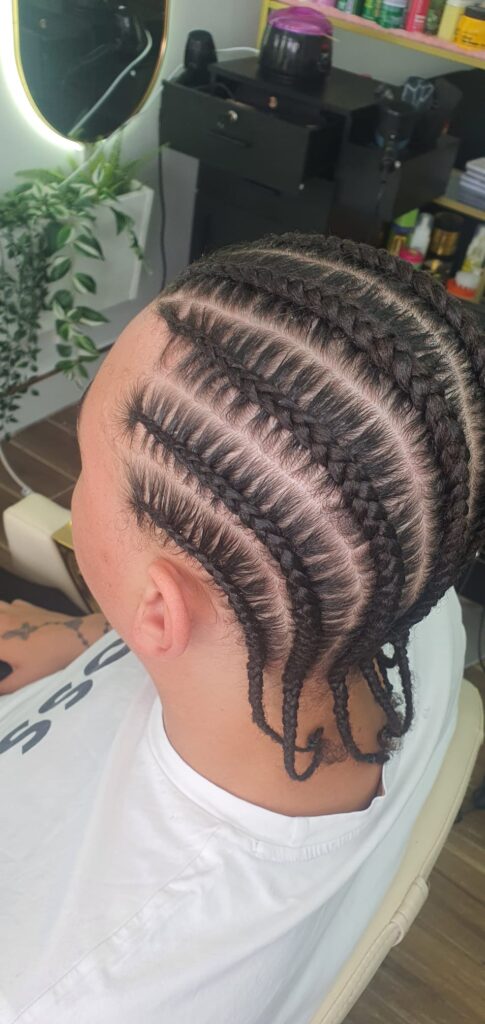 Side view feed in cornrows with neat parting by Lorellin Hair & Beauty in Wolverhampton