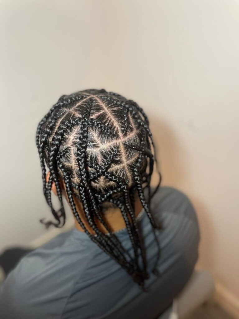 Cornrows with star pattern design and clean parting by Lorellin Hair & Beauty in Wolverhampton
