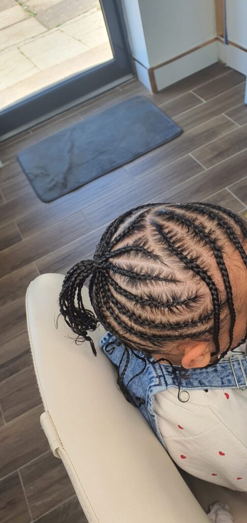 Kids cornrows with curved pattern and ponytail by Lorellin Hair & Beauty in Wolverhampton