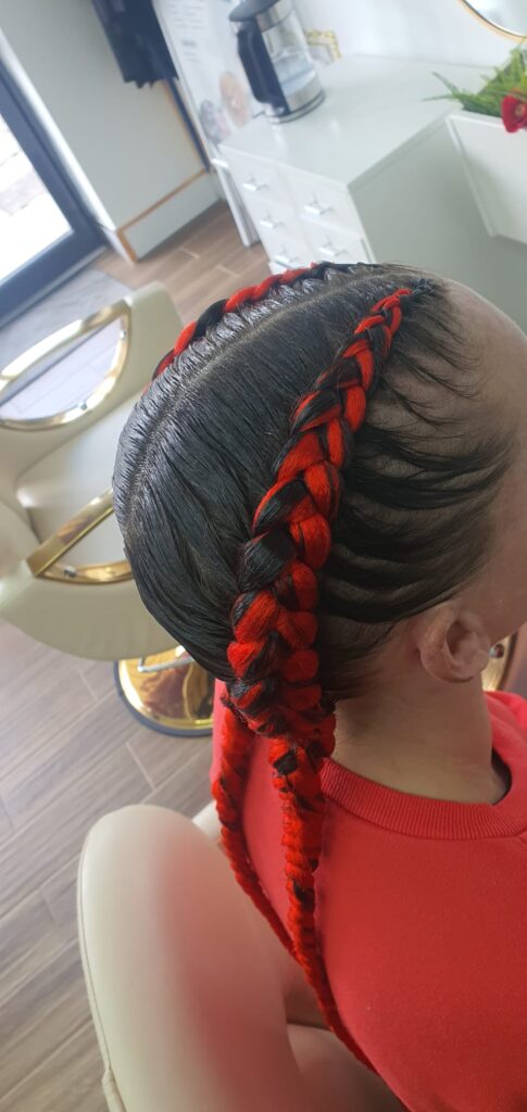 Slick braided ponytail with red and black colour by Lorellin Hair & Beauty in Wolverhampton