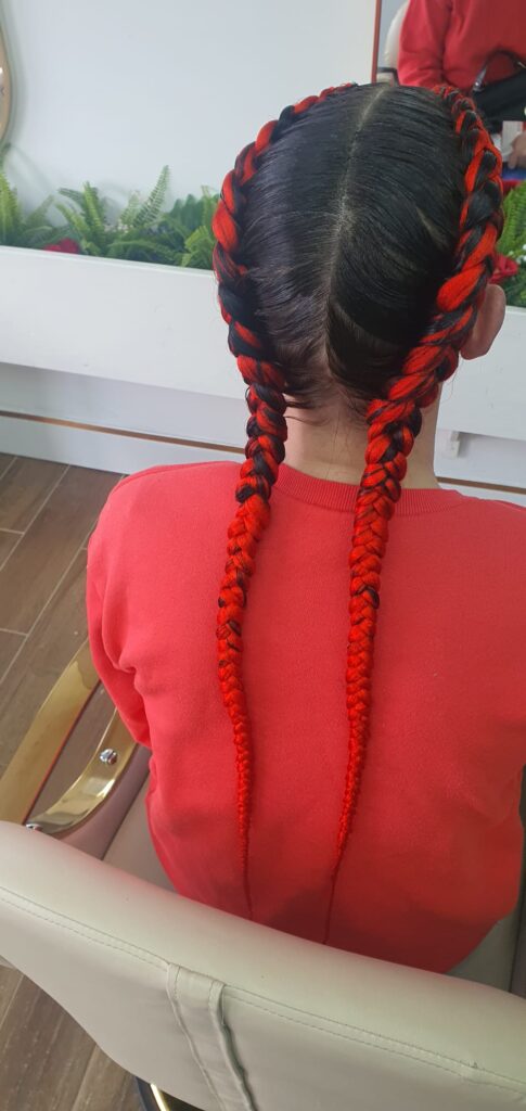 Double braids with red and black colour by Lorellin Hair & Beauty in Wolverhampton